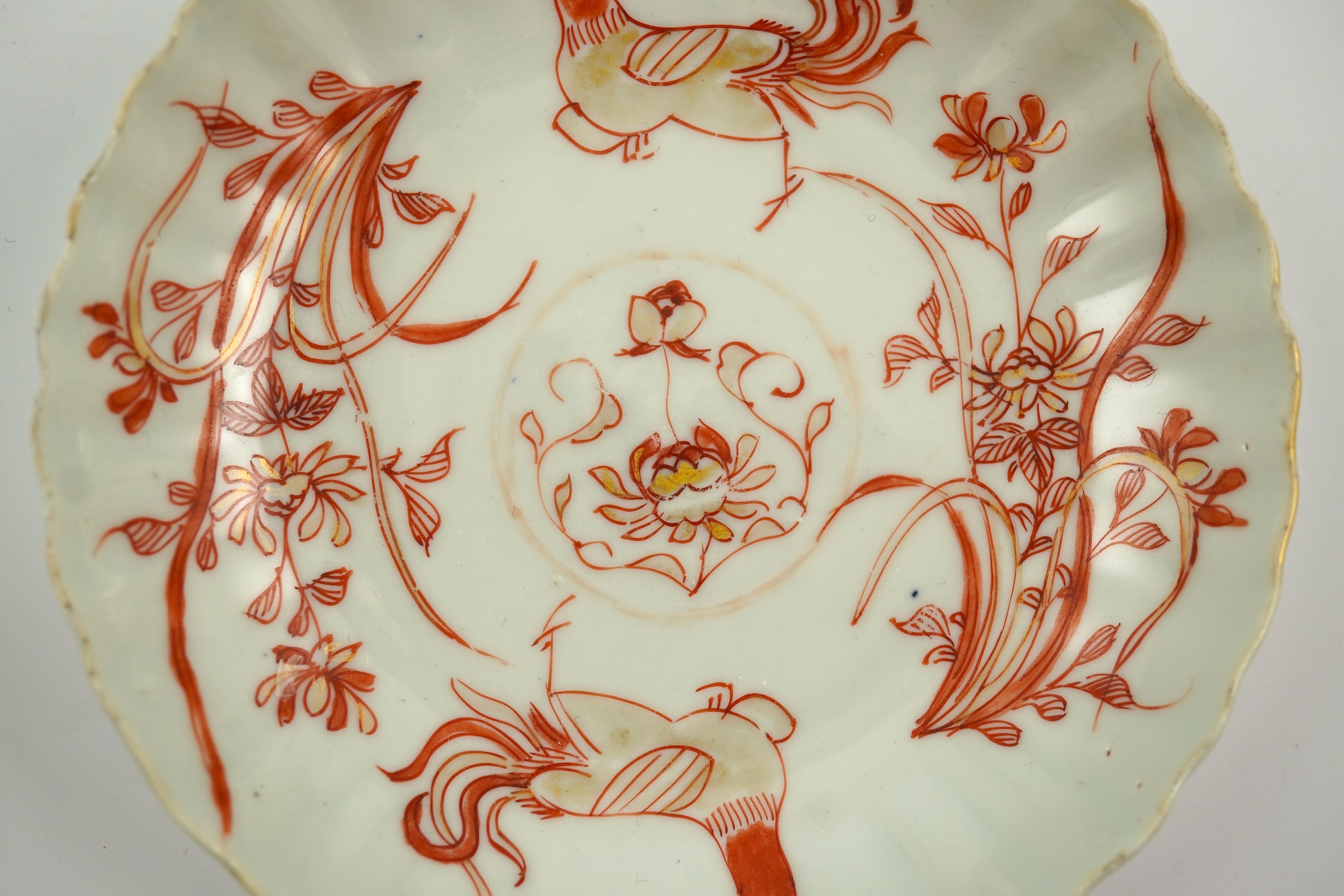 A Chinese rouge de fer tea bowl and saucer and a similar cup, Qianlong period